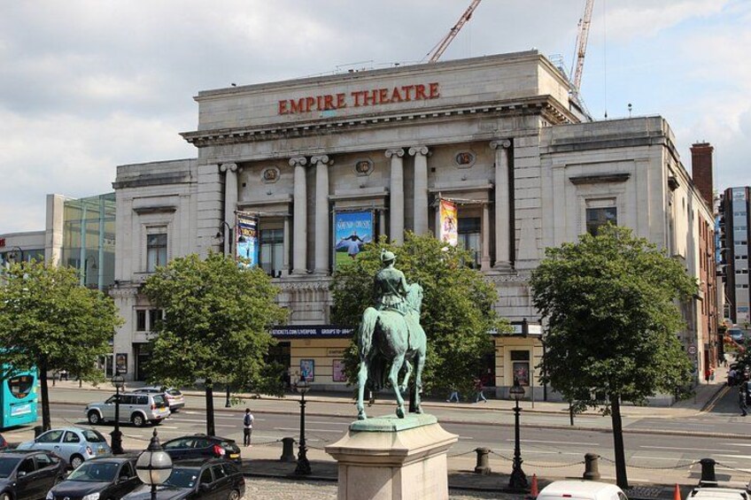 The Empire Theatre with a statue of a horse and rider in front. 4