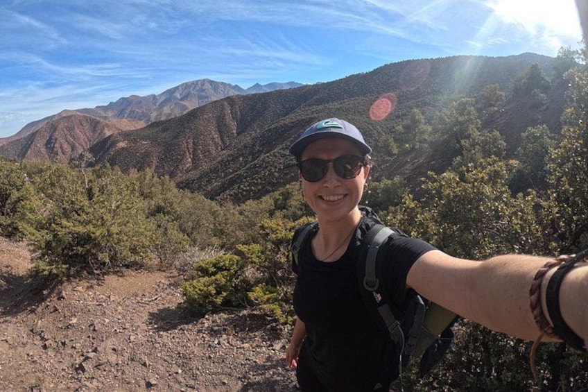 A hiker in a mountainous area with a clear sky. 2