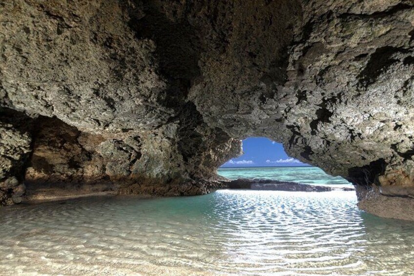 A cave opening to a clear turquoise sea. 2