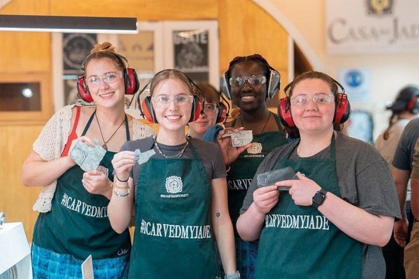 People wearing aprons and headphones, standing in a room with wooden walls and a sign that reads 'Casa-Jua'. 5