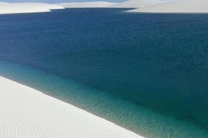 A beach with clear turquoise water and white sand. 2