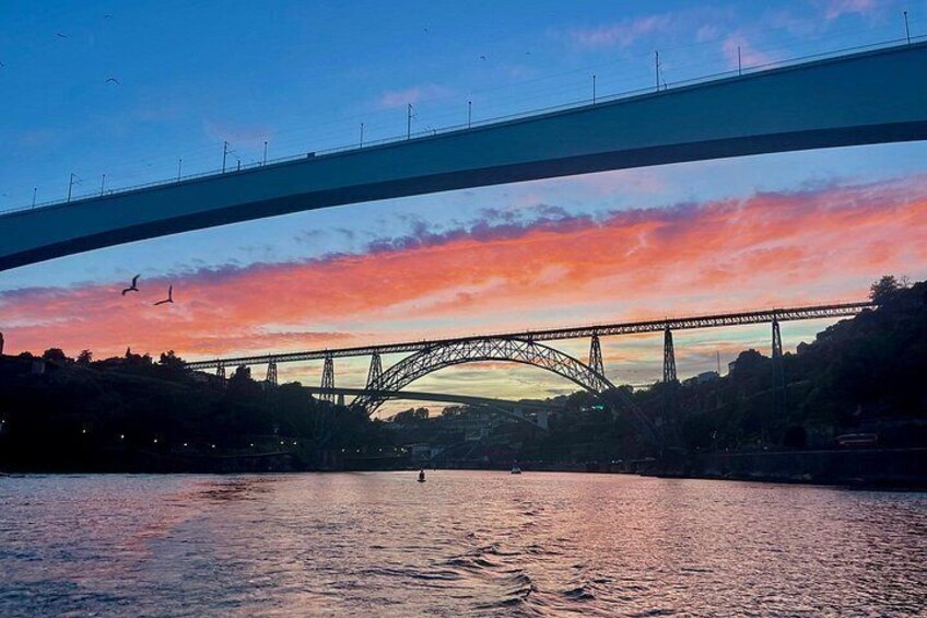 A bridge over a river with a sunset sky. 4