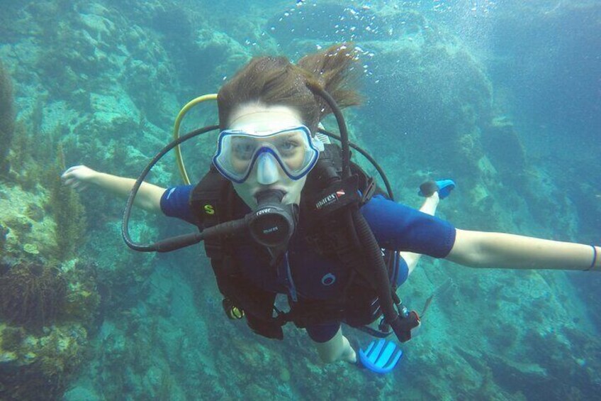 A person scuba diving underwater with fins and a diving mask. 3