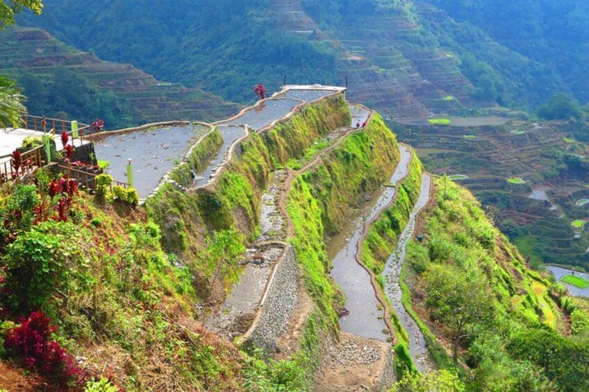 Terraced rice fields, a river, and a bridge. 3