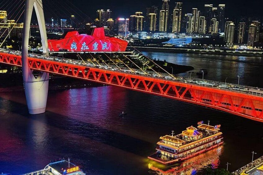 Un pont rouge, avec un bateau au premier plan et une vue sur les bâtiments d’une ville en arrière-plan. 3