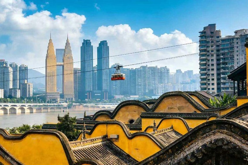 A yellow building with traditional architecture, a cable car, and a city skyline with modern skyscrapers. 5