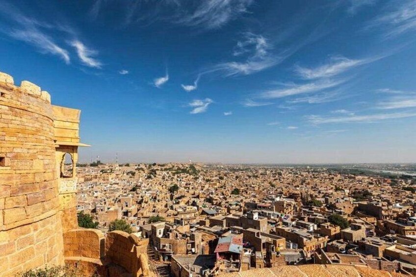 A historic stone fortification overlooking a densely populated cityscape. 3