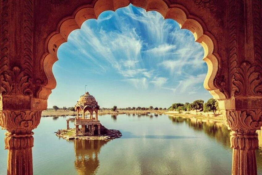 A traditional Indian pavilion on a lake, surrounded by ornate architecture. 5