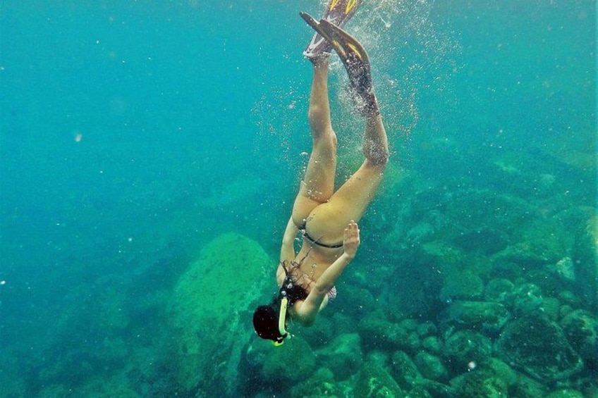 A person scuba diving underwater. 4