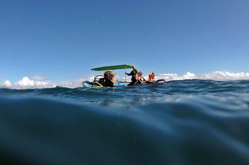 Two people in a kayak on a calm sea with a clear sky. 2
