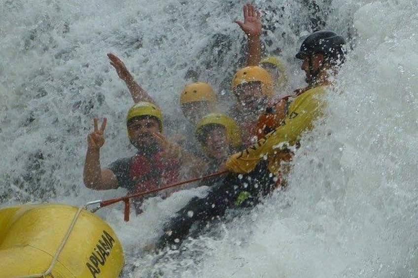 People in a raft navigating through a turbulent river. 4
