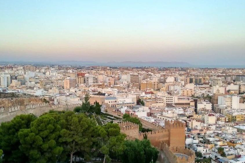 A cityscape with a prominent historical wall and dense urban buildings. 2