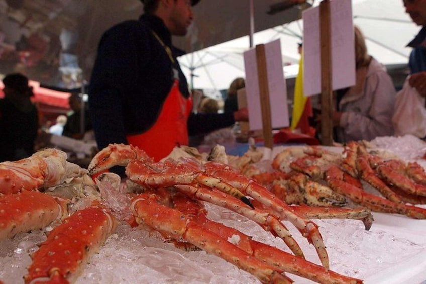 A seafood market with crab legs displayed on ice. 3