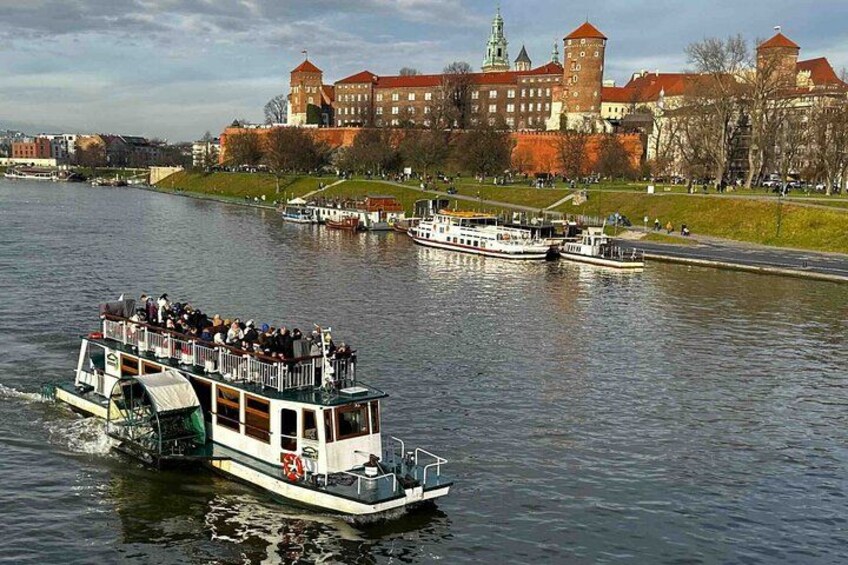 A river with boats, a castle, and a bridge. 1