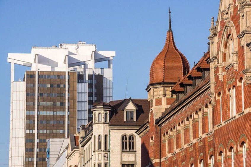 A cityscape with modern high-rise buildings and historic architecture. 4