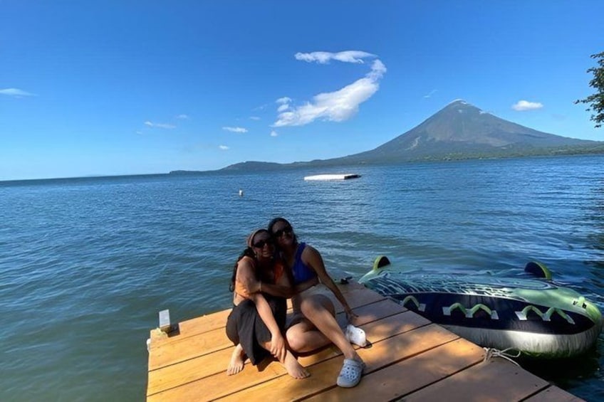 A wooden dock extending into calm water with a mountain in the background. 4