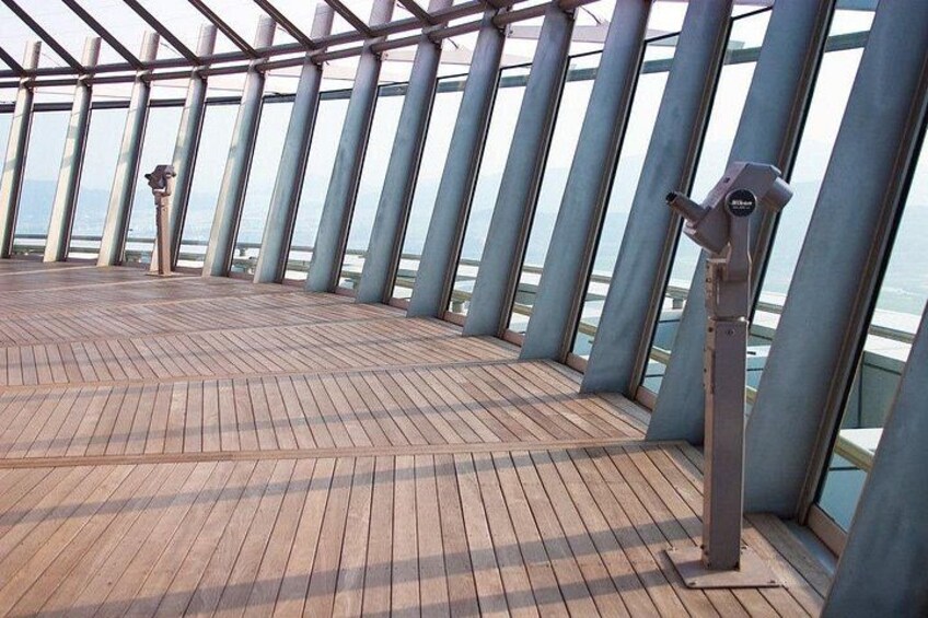 A wooden deck with metal railings and binoculars. 4