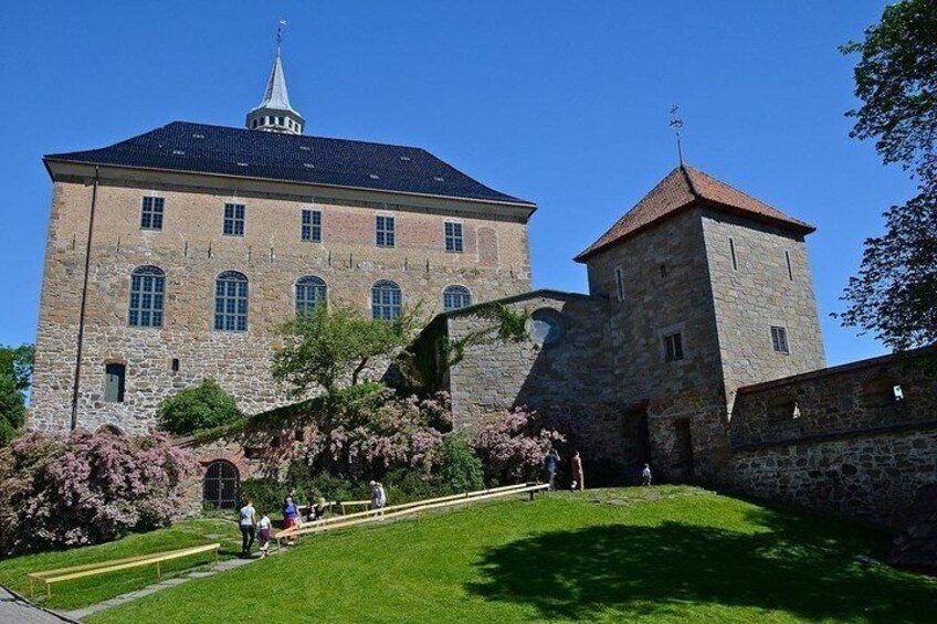A historic building with a tower and a large central structure. 1