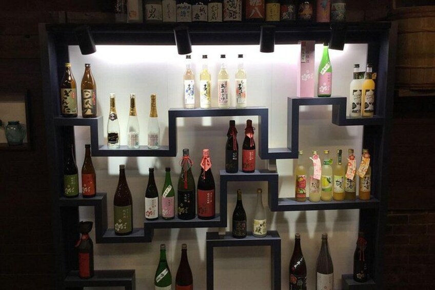 A display of various bottles, likely alcoholic beverages, arranged on shelves. 1