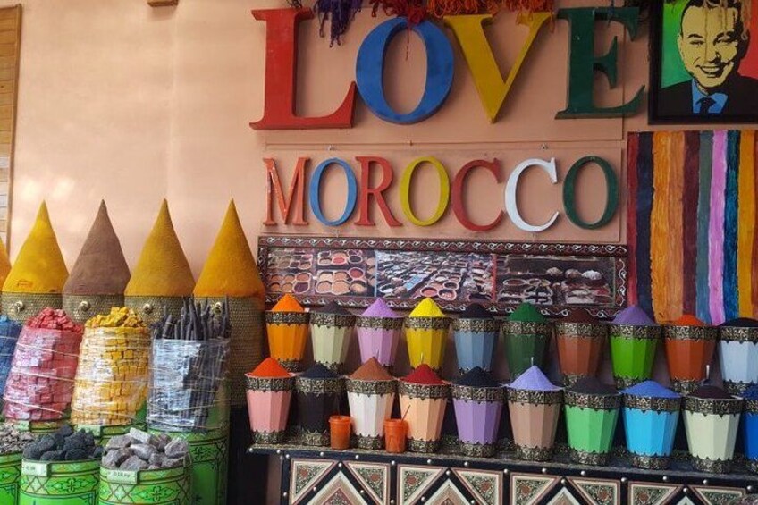Colorful cones, a sign with 'LOVE MOROCCO,' and a display of sunglasses. 1