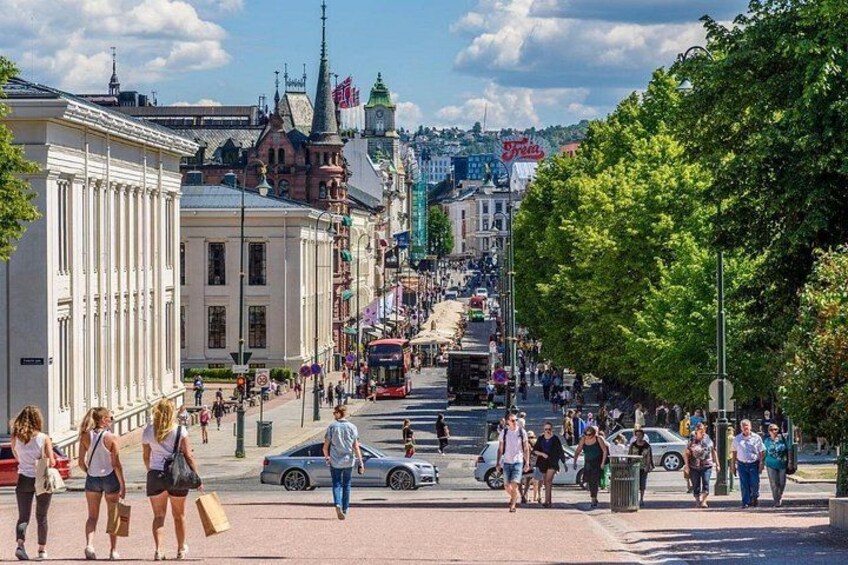A busy urban street with pedestrians, cars, and a tram. 2