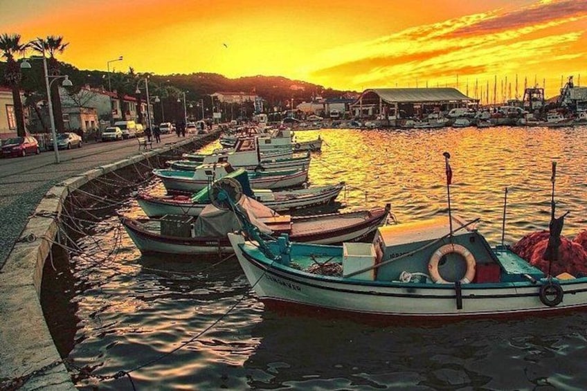 A harbor with boats docked along the waterfront during sunset. 4