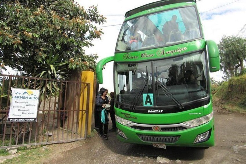 A green double-decker bus labeled "Tours Class Arequipa" parked at a gate. 1