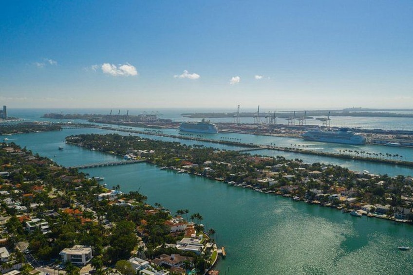 A coastal cityscape with a marina, bridges, and a clear sky. 5