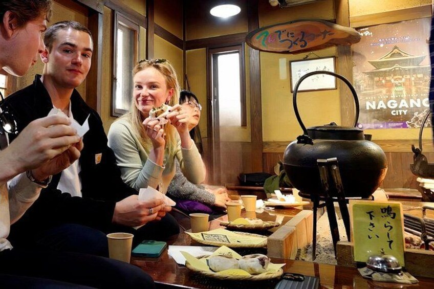 Smiles, steam, and freshly grilled Oyaki – a heartwarming experience at a traditional Japanese hearth. 3