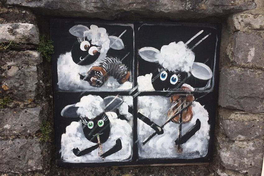 A wall mural with four sheep characters. 2