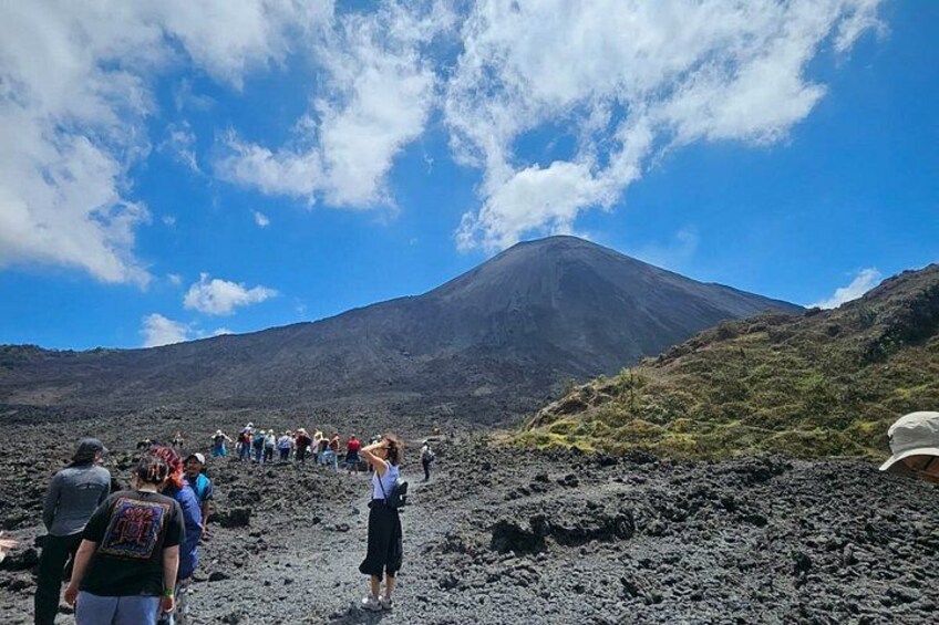 A group of people observing a volcano. 2
