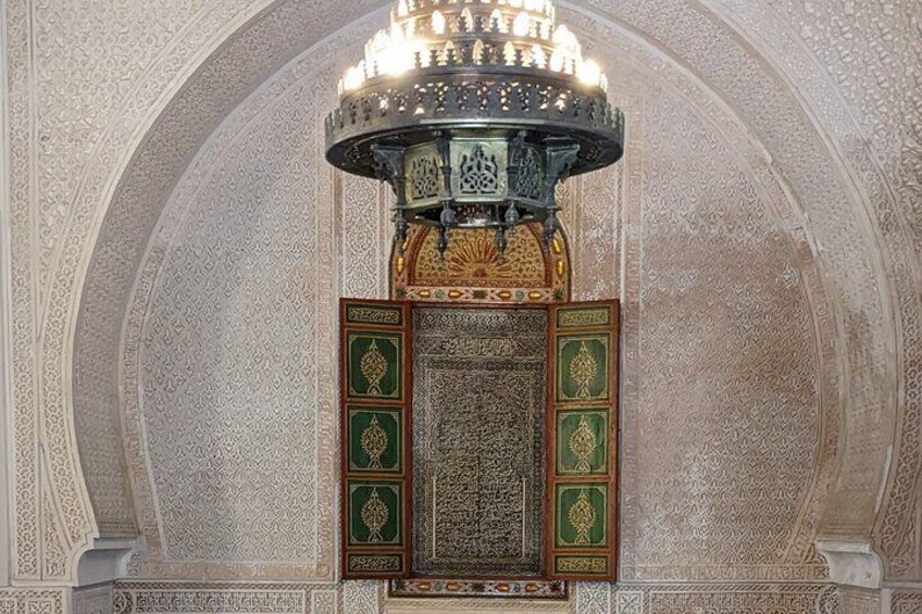 An ornate Islamic architectural detail with a chandelier and intricate wall patterns. 5