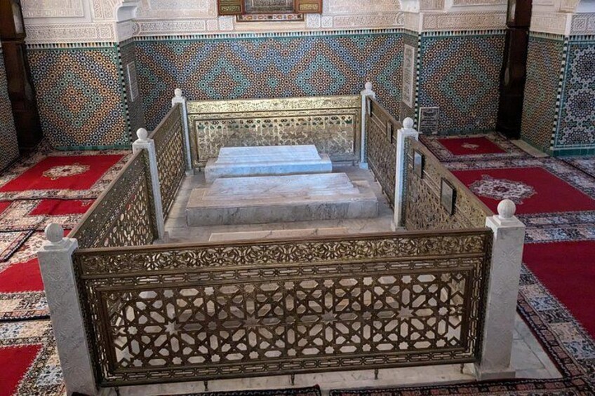 A staircase with intricate metal railings and a patterned carpet. 4