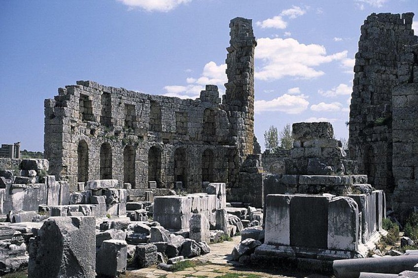 Ancient ruins with stone columns and arches. 1
