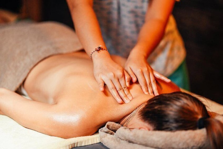 A person receiving a back massage. 3