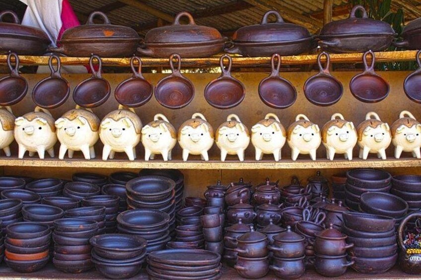 Ceramic pots and teapots on shelves. 1