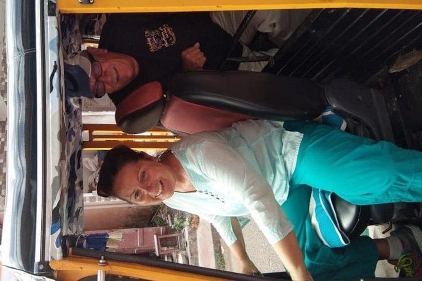A person seated in a vehicle with a black seat and a yellow roof. 3