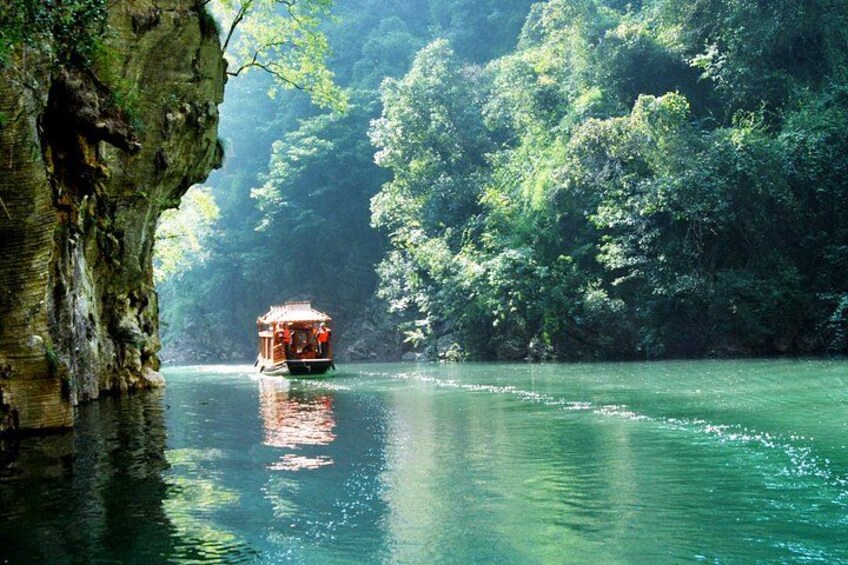 A boat on a river surrounded by dense forest. 3