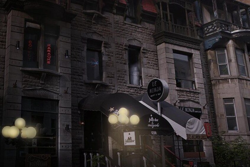 A building with a sign reading 'Le Ninja' and a neon sign above the entrance. 1