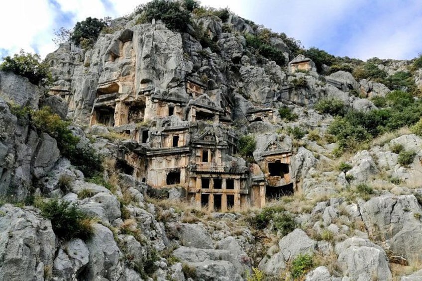 Ancient rock-cut tombs on a hillside. 3