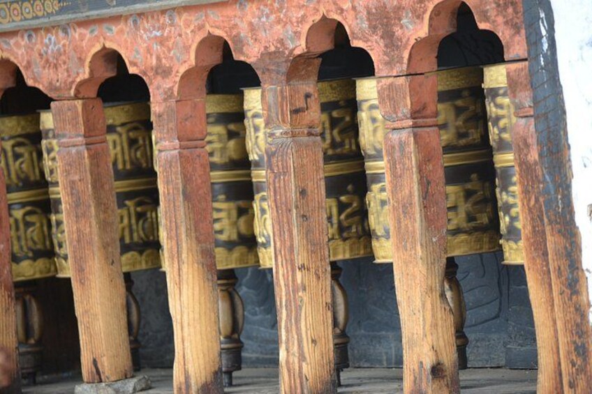 A wooden structure with carved figures and arches. 3