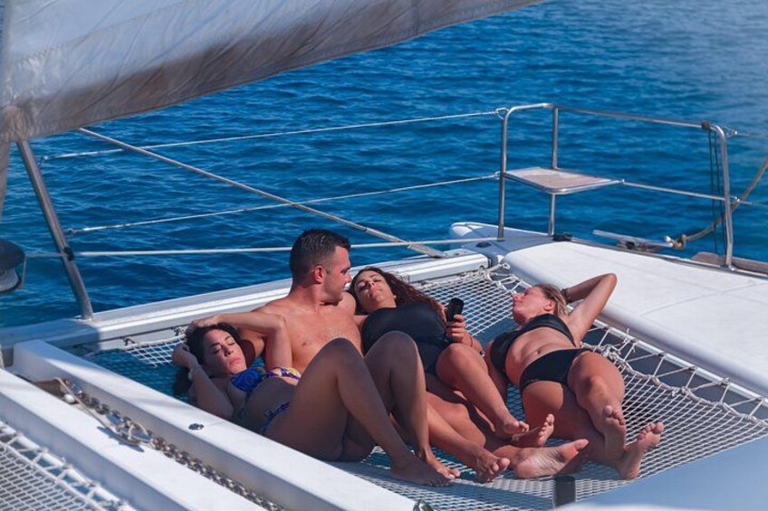 A group of people relaxing on a boat's deck. 1