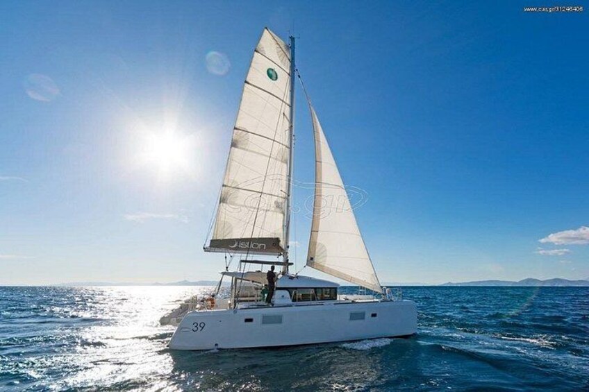 A sailboat with a number 39 on its side, sailing on a calm sea under a clear sky. 4