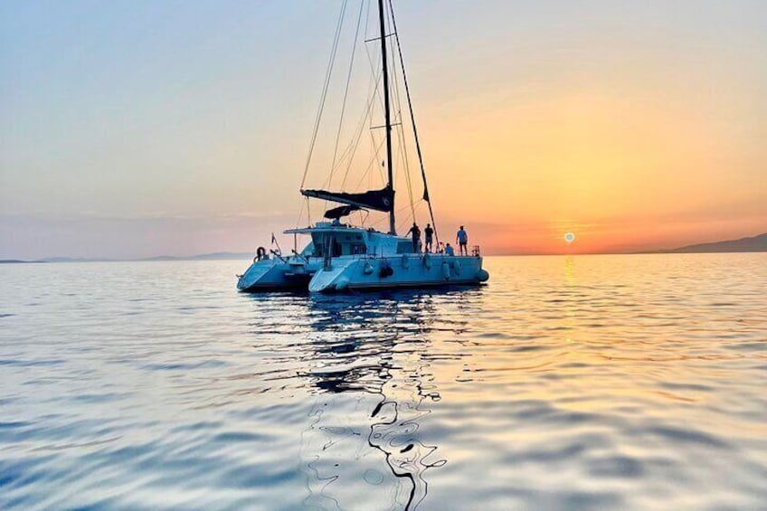 A sailboat on calm waters at sunset. 3