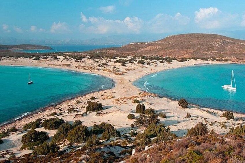 A coastal landscape with a sandy beach, clear turquoise waters, and a sailboat. 2