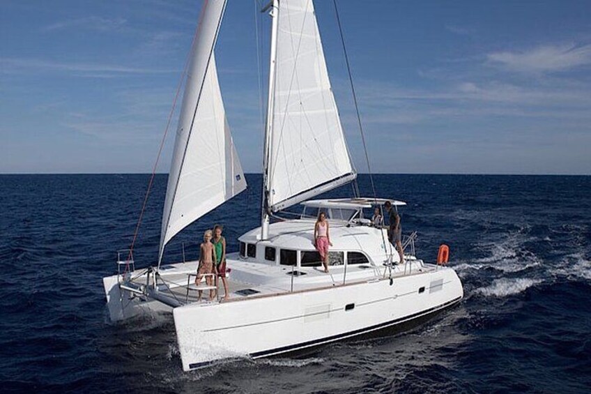 A white sailboat with two sails on the water. 5