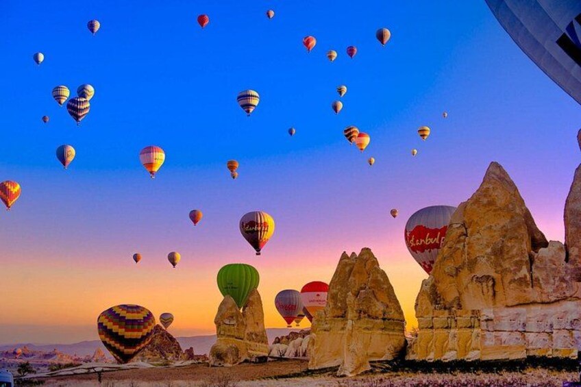 Hot air balloons, rocky formations, and a sunset sky. 5