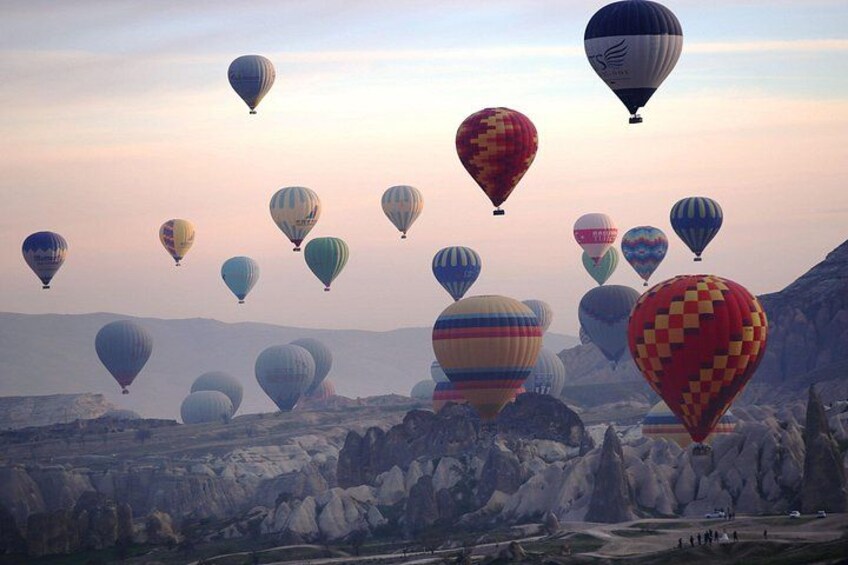Hot air balloons over a rocky landscape. 4