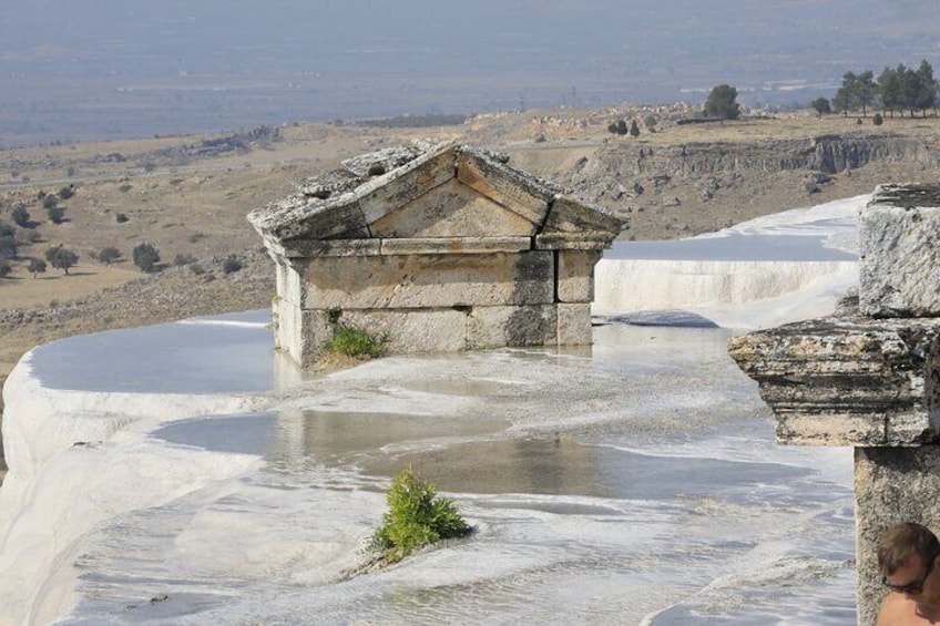 Terraced pools with a stone structure in the foreground. 1