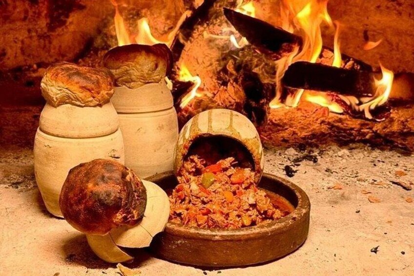 Clay pots, a fire, and a bowl of food. 4